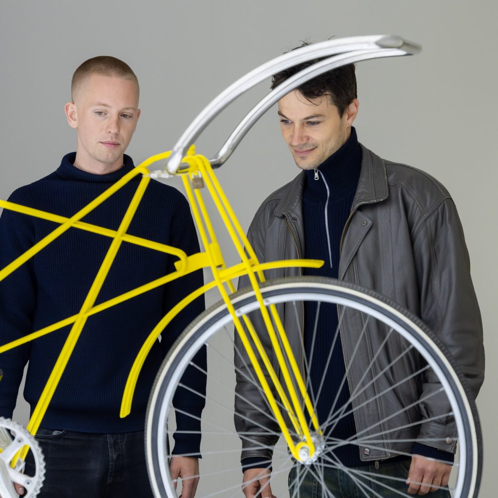 Two guests looking at the bike in Danish Modern