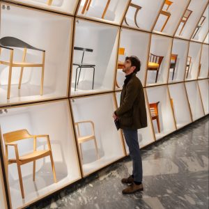 Guest looking at chairs in the Danish Modern exhibition